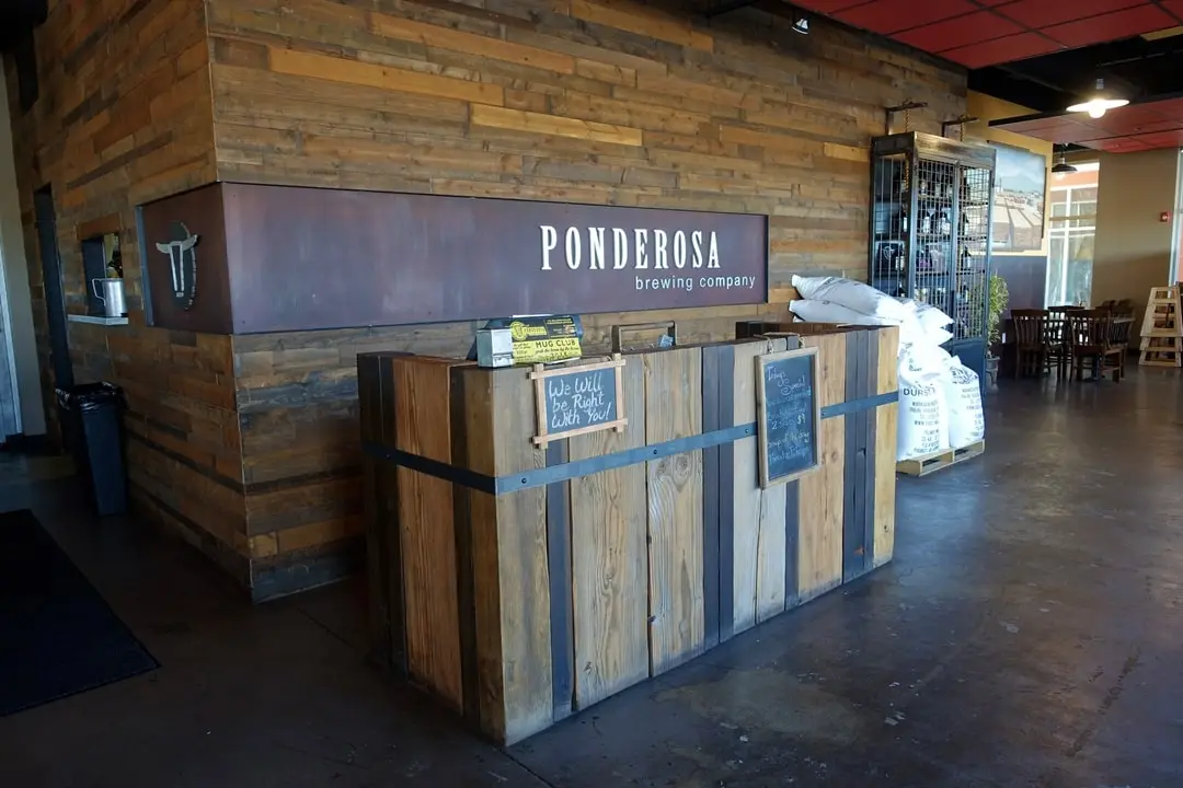 Entrance welcome desk next to supply bags and additional seating area.