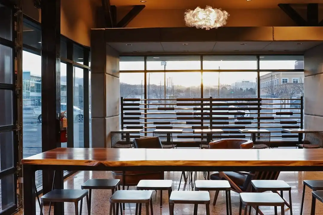 View of seating areas under wood beam roof.