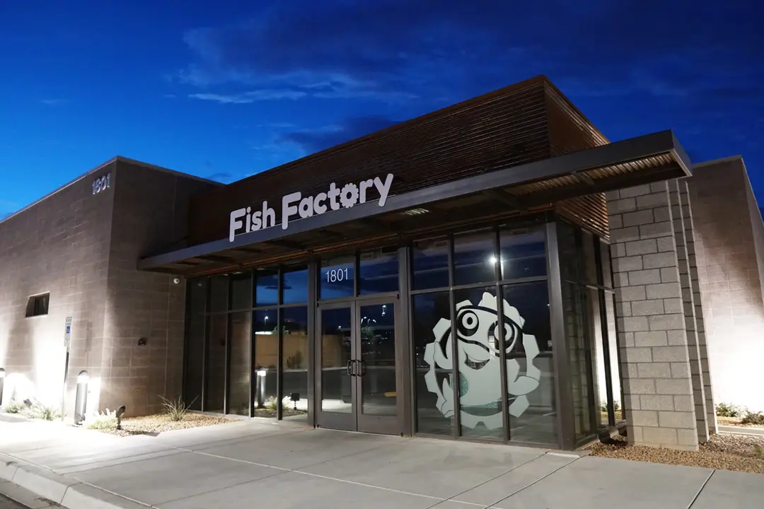 Fish Factory Swim School entrance after sunset.
