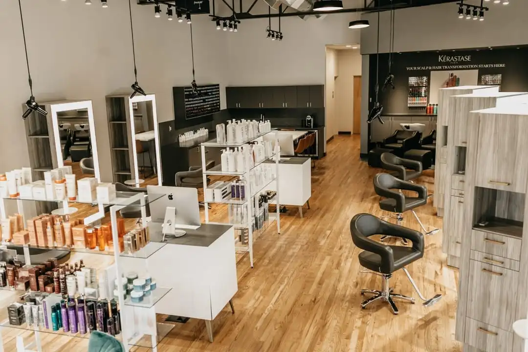 Salon seating and store with product on glass shelves.