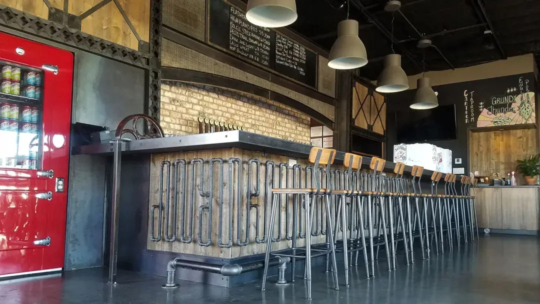 Long bar with metal trim and piping accents.