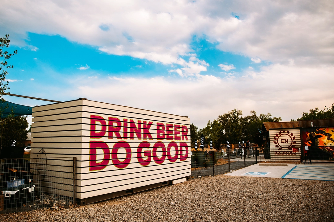 Storage building with "Drink Beer Do Good" written in large red characters.