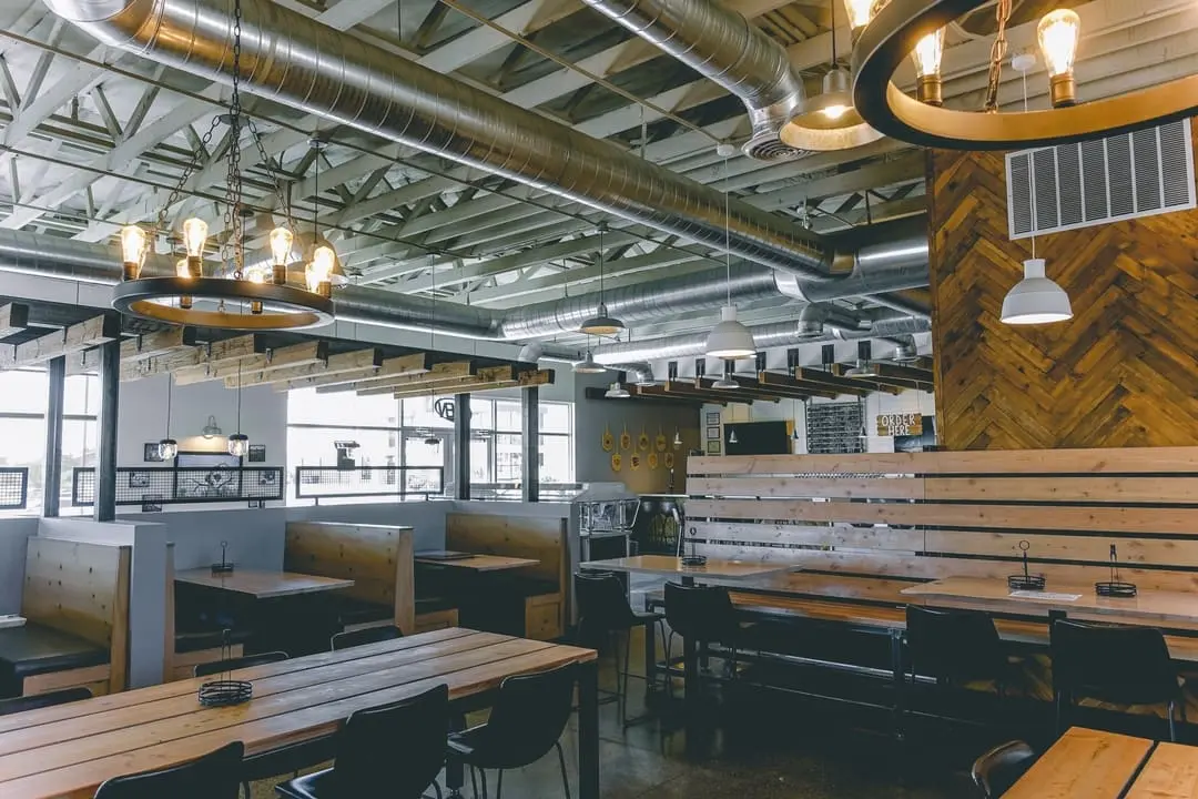 View of seating areas under wood beam roof.