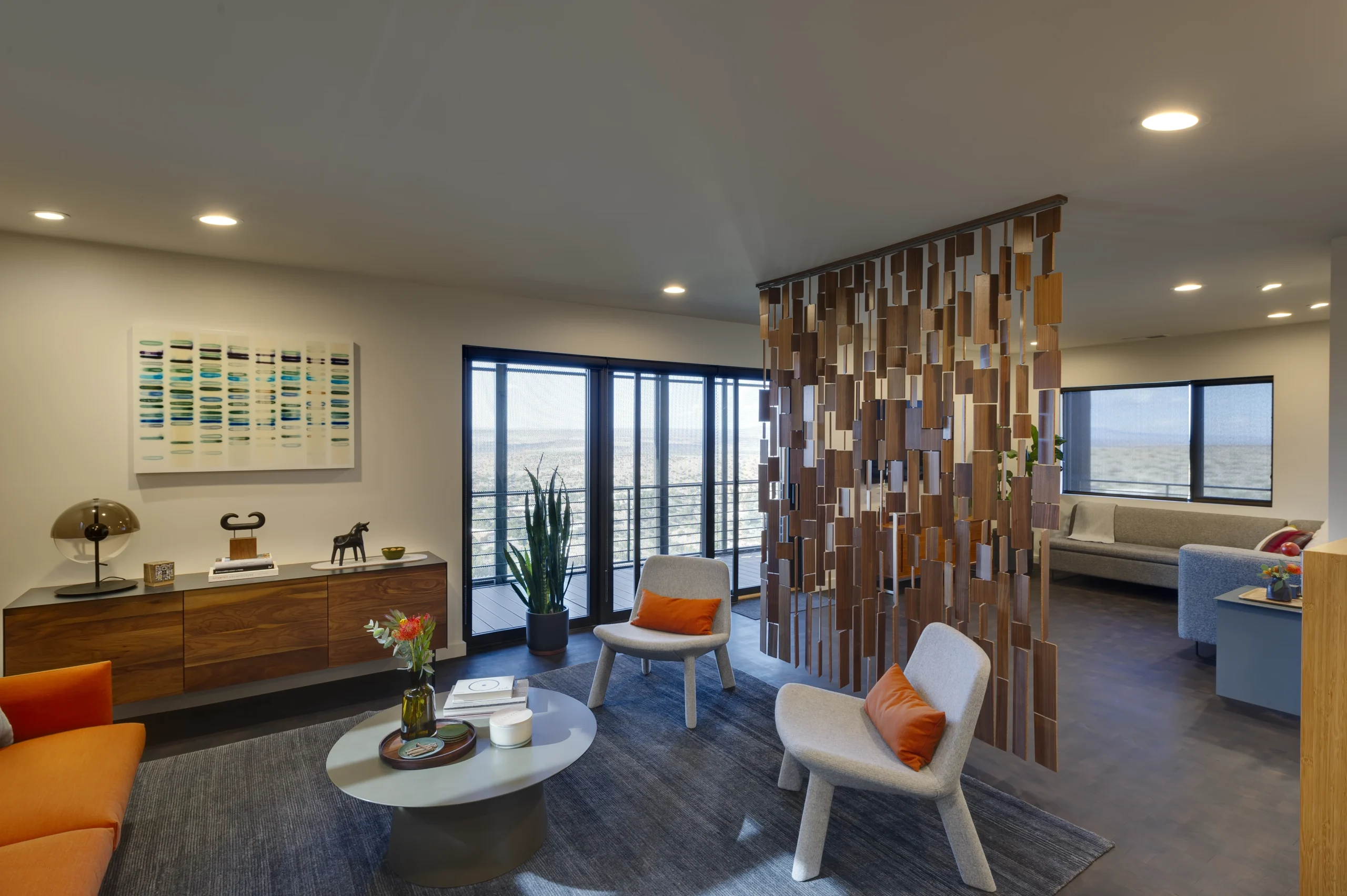 Living room with an intricate, modern wall divider in the center