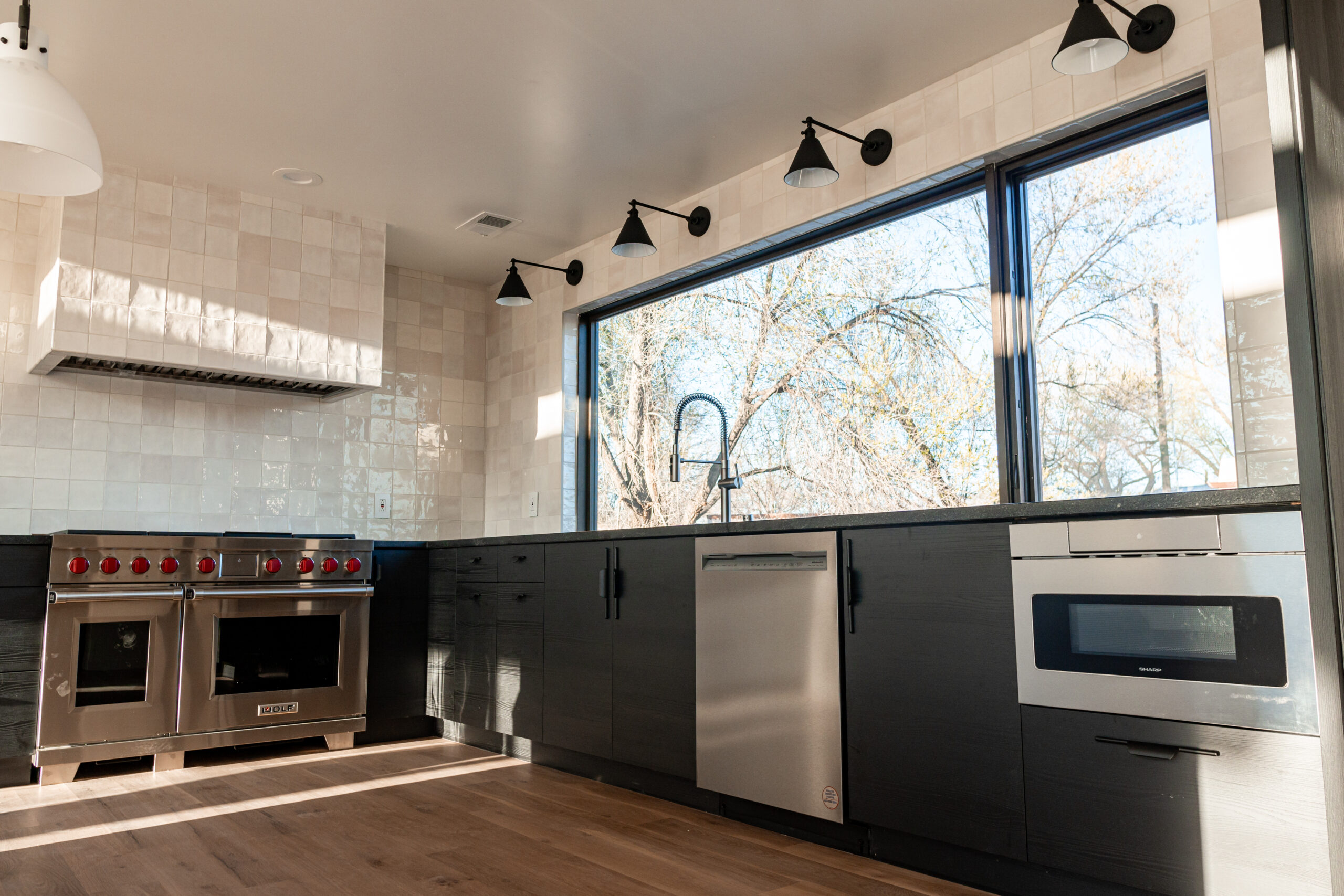 View of the kitchen with modern, sleek finishes in the Masters and Borin home