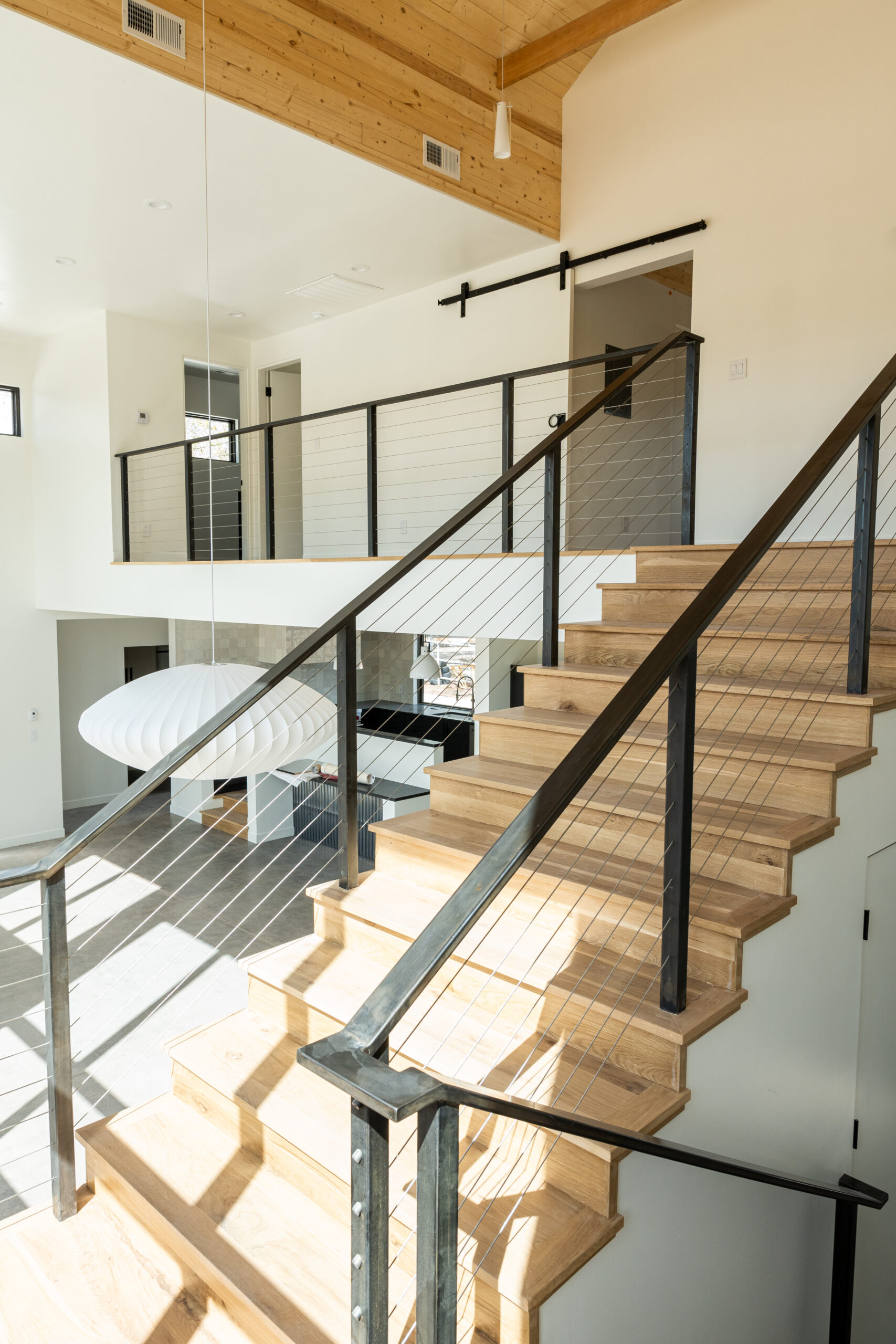 Stairs with custom steel railing in the Masters and Borin home