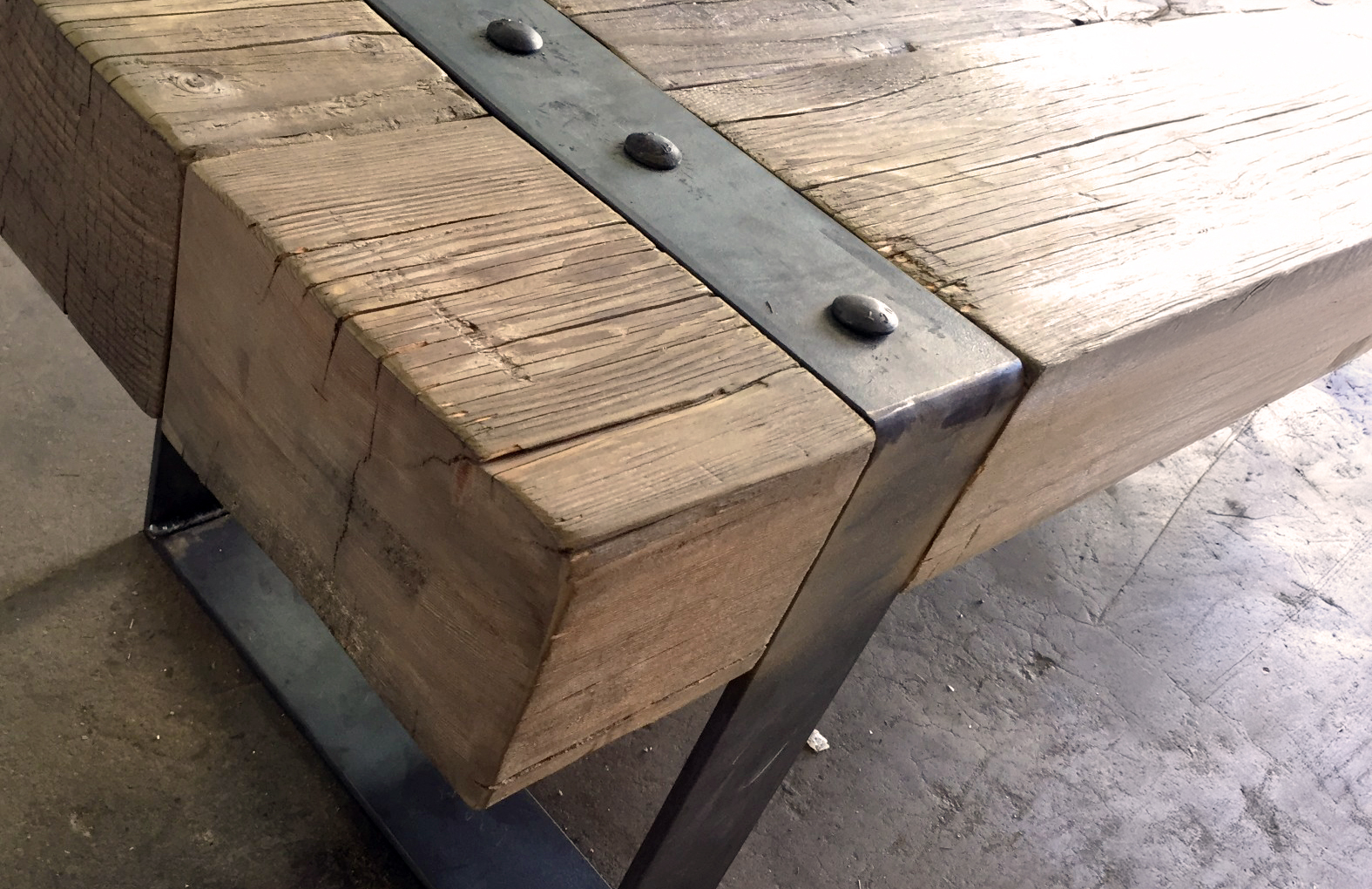 Closeup shot of a wooden tabled with steel finishes in their studio