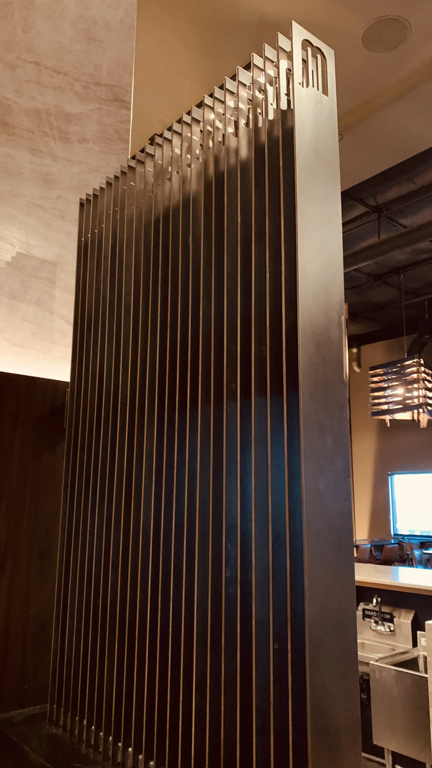 Sleek, steel divider with Marble's M at the top